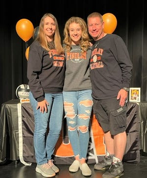 Bloom-Carroll senior Kaitlyn Young signed her national letter of intent to play volleyball at the University of Findlay. She is pictured with her parents, Nikki and Sean Young.