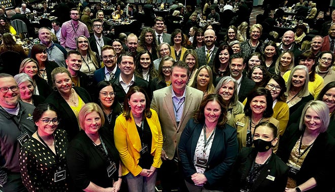 First Merchants Bank CEO Mark Hardwick, center, and employees of the company recently celebrated being named one of the "Best Banks to Work For" for 2022. Shown, the company gathering for another bank event.