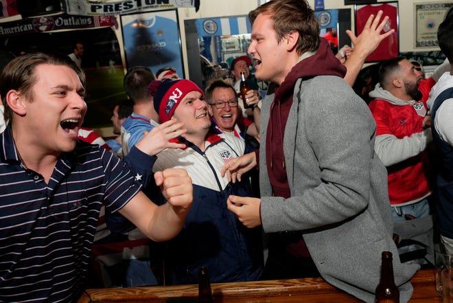 Fans interact at Mulligan's Pub, in Hoboken, as the USA team scores the first goal of their World Cup match against Wales.  Monday, November 21, 2022