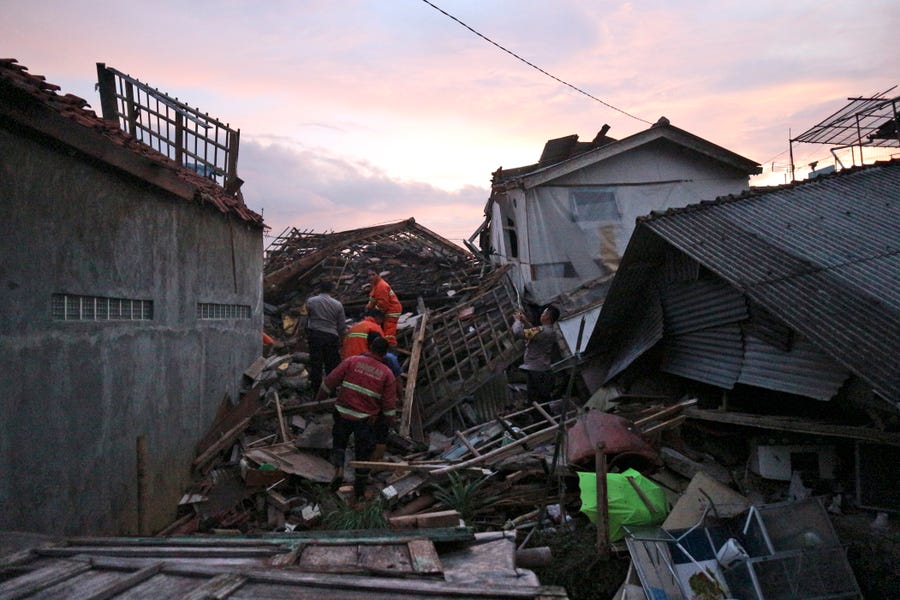 Rescuers search for survivors at the ruins of houses damaged by an earthquake in Cianjur, West Java, Indonesia, Monday, Nov. 21, 2022.