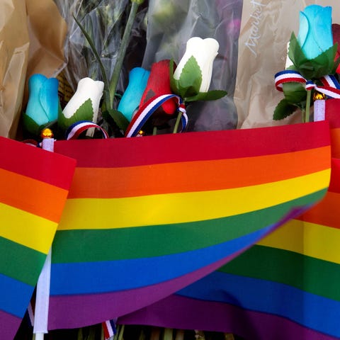 Pride flags are seen at a memorial for the victims