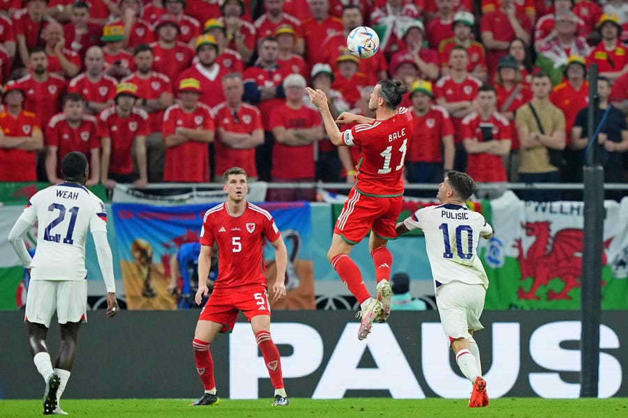 Wales forward Gareth Bale (11) heads the ball against United States of America forward Christian Pulisic (10) during the first half during a group stage match during the 2022 FIFA World Cup at Ahmed Bin Ali Stadium.