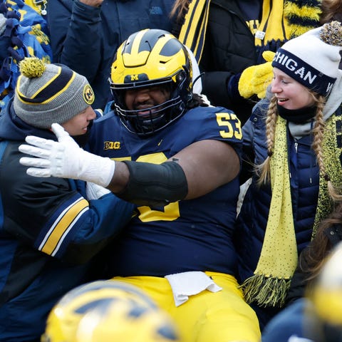 Michigan players celebrate with fans after a scare