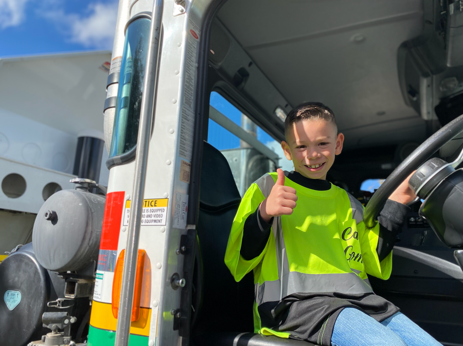 Carter Gomes, 7, gives a thumbs up from a Turlock Scavenger garbage truck on Nov. 7 as the Make-A-Wish Foundation granted him his wish of becoming a member of the garbage company's collection team for a day in Turlock, California.