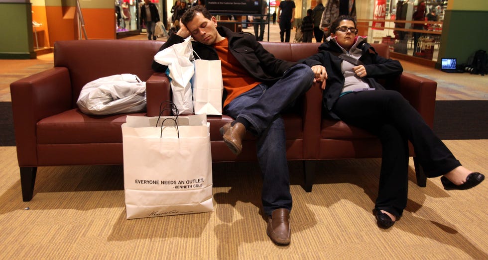 (L to R) Hamid Ghadaki  and his wife Hedieh Ghanbari from Toronto, Ontario, sleep during Black Friday sales at Great Lakes Crossing Outlets in Auburn Hills, Mich., on Nov. 26, 2010.