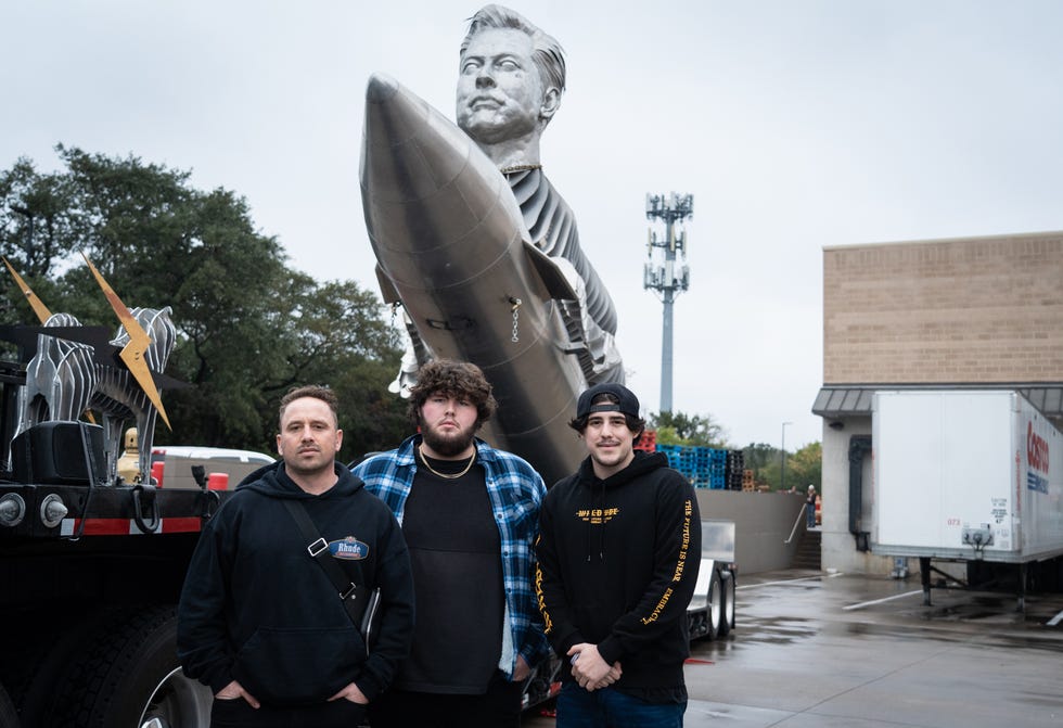 Ashley Sansalone, left, founder of Elon GOAT Token, stands in front of the Elon GOAT Token Monument with CMO Alec Wolvert, center, and co-founder Richard Latimer in the South Austin Costco parking lot, November 22, 2022. The monument is a $600.00 -Project honoring Elon Musk and his contributions to cryptocurrency and a marketing strategy to promote $EGT. 