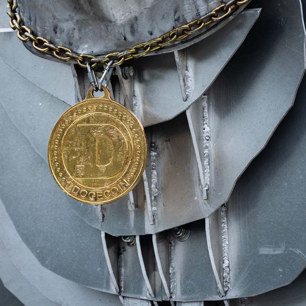 Displaying a Dogecoin necklace — a tribute to Musk's contributions to Dogecoin and other cryptocurrencies — the Elon GOAT Token Monument attracts passers-by in the South Austin Costco parking lot on November 22, 2022.  The monument is a $600.00 project to honor Elon Musk and his contributions to cryptocurrency and a marketing strategy to promote $EGT.