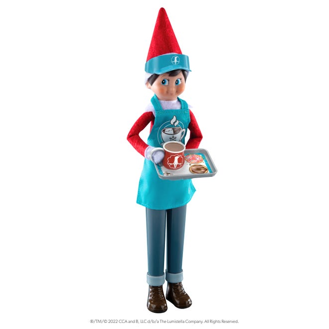 A Scout Elf with hot cocoa accessories, including a stand to keep it upright.