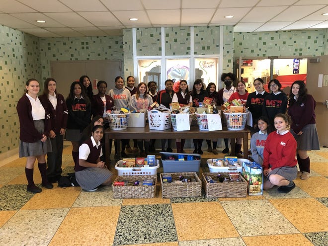 Mother Seton Reginal High School Student Council members and class officers are shown with completed food baskets ready to be delivered.