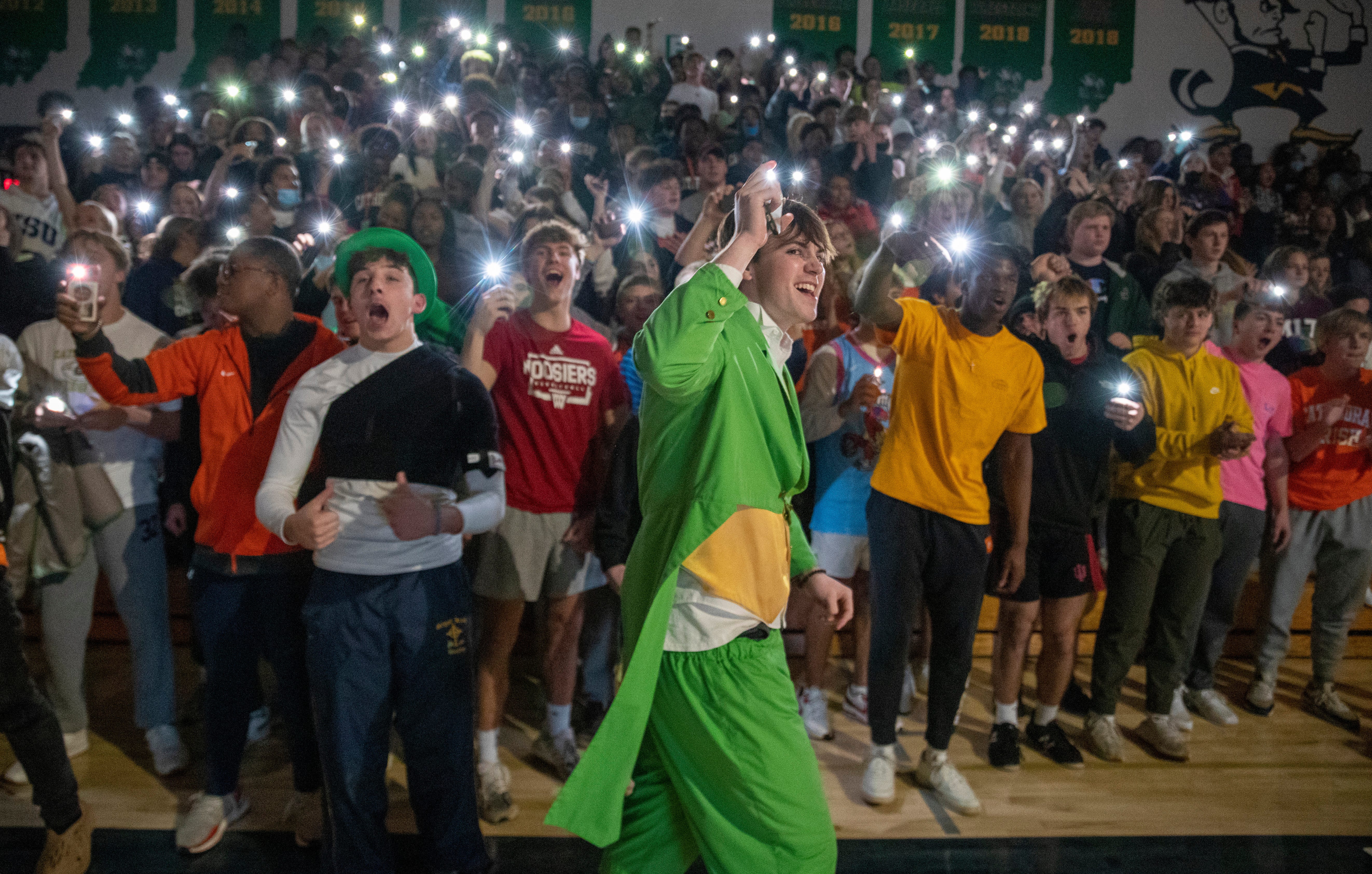 Will Mayer, 17, wears a leprechaun outfit as he and fellow students get hyped for boys action from Cathedral, Indianapolis, Wednesday, Jan. 12, 2022. Carmel High 
School won 71-57. 