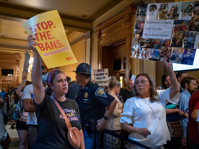 People march in a crowded area outside the Senate chambers at the Indiana Statehouse on July 25, 2022, the day lawmakers began a special session to ban abortion.  Court challenges prevented the law from coming into force.