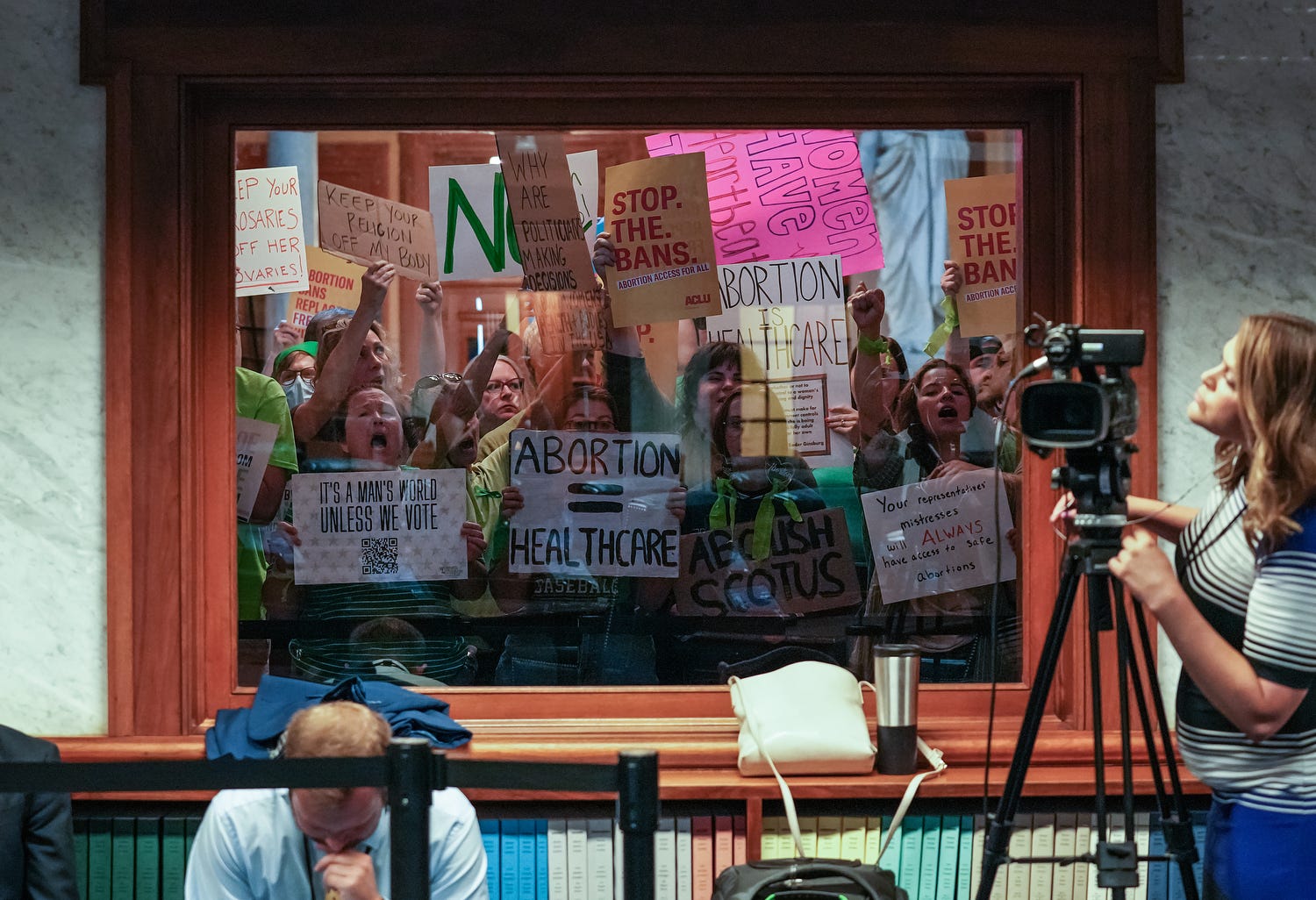 Demonstrators protest outside the Senate chambers before the start of a special session on July 30, 2022, in Indianapolis.