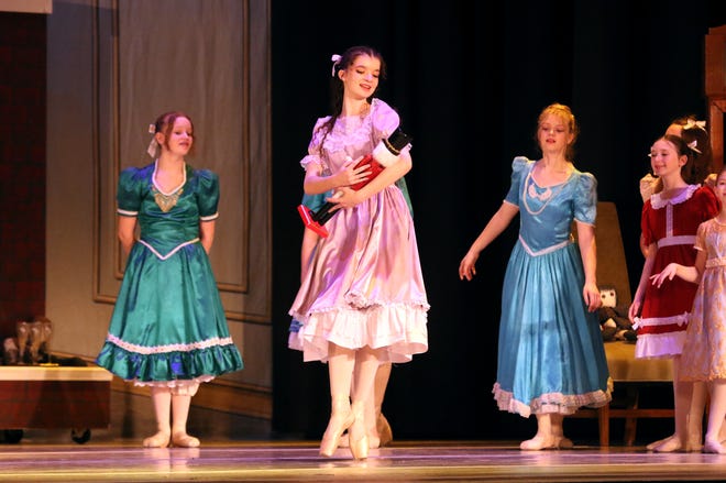 Clara admires her nutcracker doll during a dress rehearsal for the holiday classic "The Nutcracker."