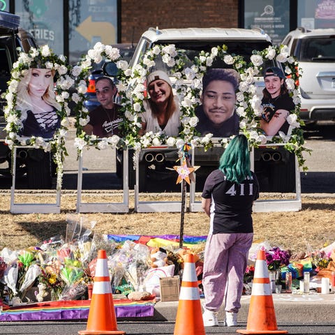 People pay their respects at a memorial display se