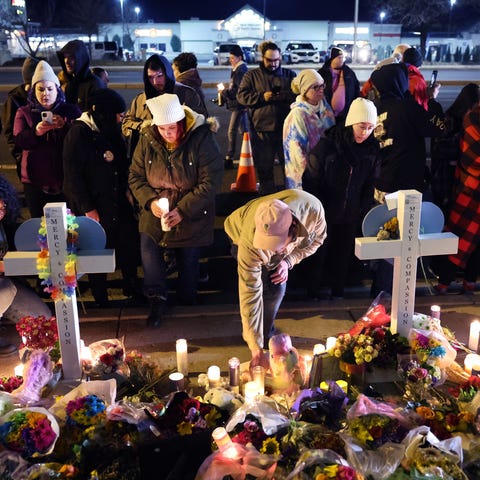People visit a makeshift memorial near the Club Q 