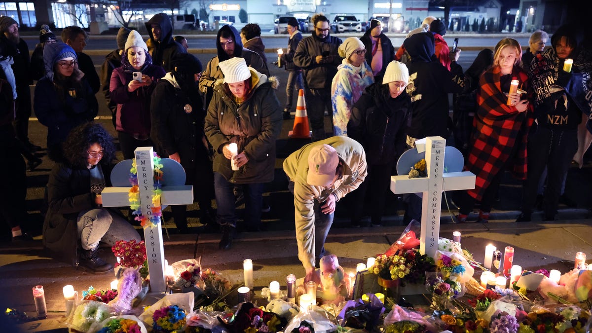 People visit a makeshift memorial near the Club Q nightclub in Colorado Springs on Nov. 21, 2022.