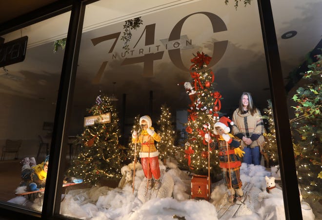 Angel Mac decorated the windows at Nutrition 740 in downtown Zanesville for the city's Storybook Christmas celebration.