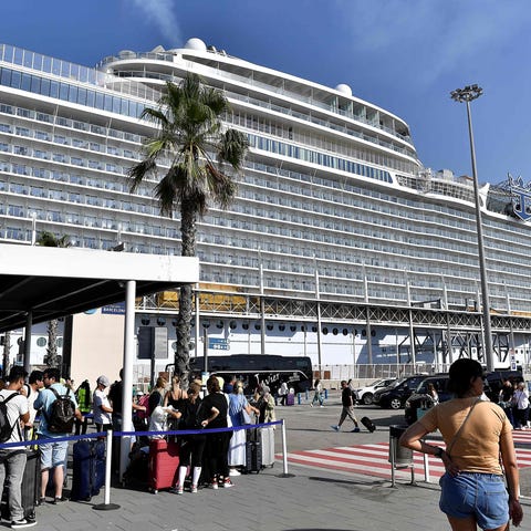 People wait for taxis after disembarking from the 