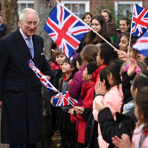 King Charles III meets pupils waving Union flags d