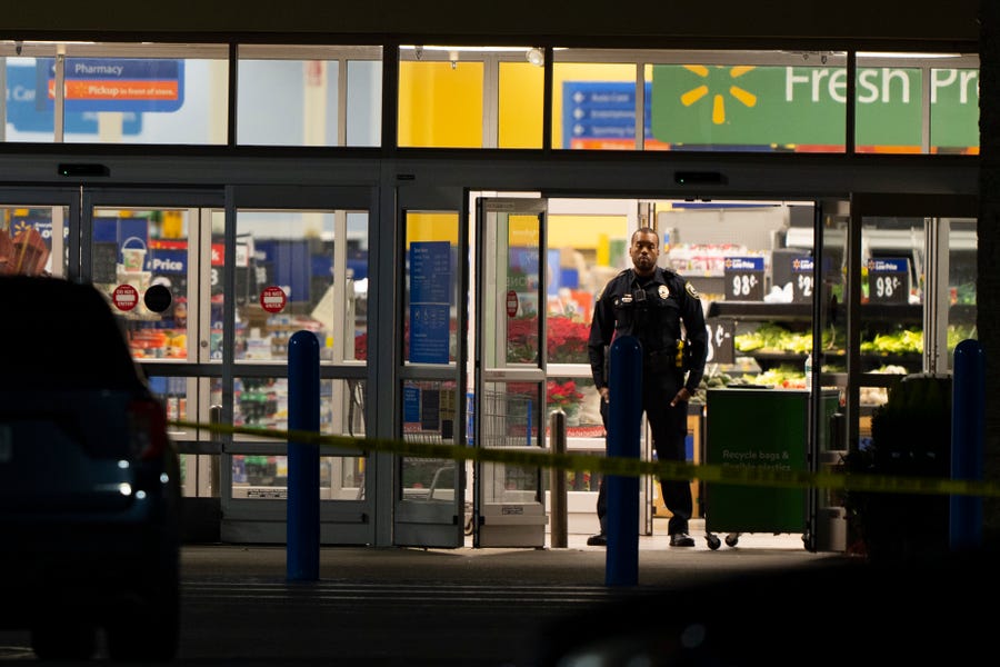 Law enforcement work at the scene of a mass shooting at a Walmart, Wednesday, Nov. 23, 2022, in Chesapeake, Va.