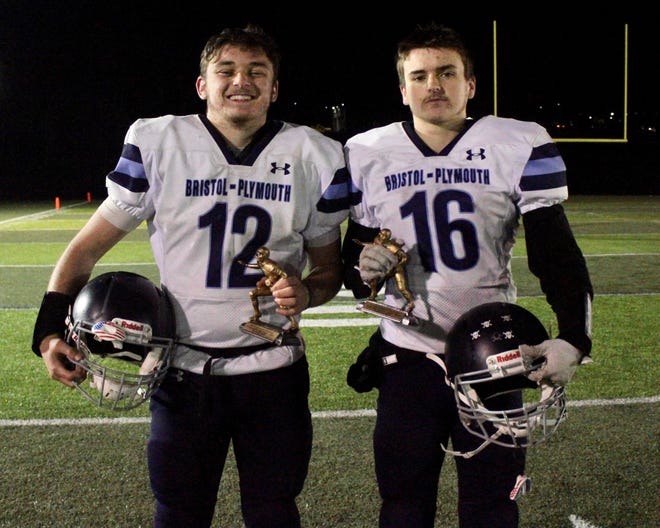 Bristol-Plymouth quarterback Ryan Donovan (left) and brother and linebacker Billy Donovan pose with their Craftsmen Offensive and Defensive Player of the Game trophies following a Thanksgiving Eve loss to Blue Hills.