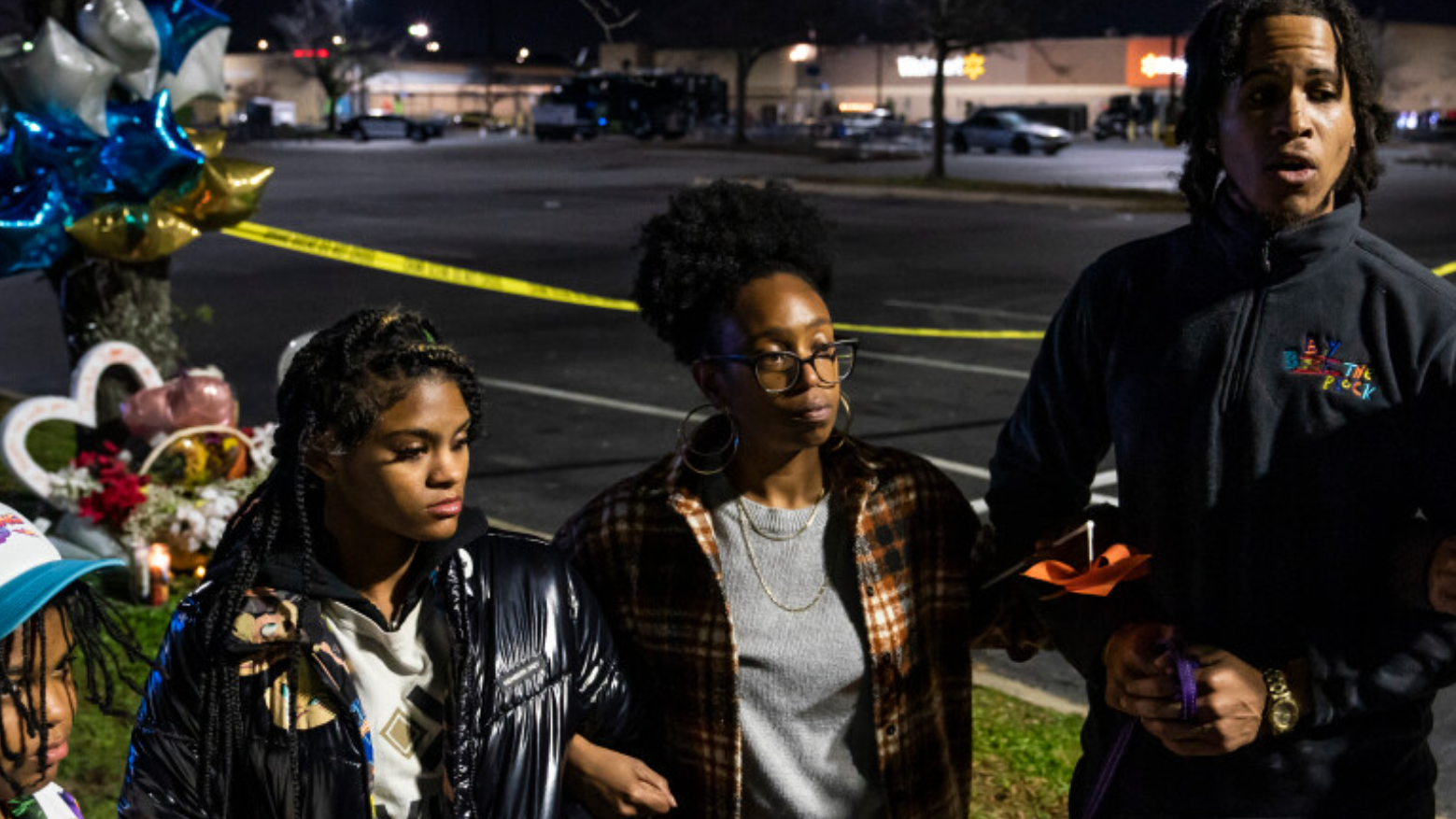 Members of the gun violence activist group, Violence Intervention and Prevention, are pictured praying at a memorial for the victims killed during a shooting at a Walmart store in Chesapeake, Virginia.