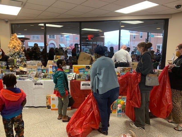 Linden residents gather to pick toys during the Columbus neighborhood's first "Carols on Cleveland" holiday event in 2021 at the Linden Transit Center.