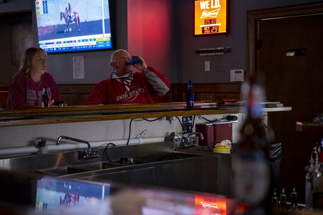 Football fans and other patrons hang out and chat over drinks at Liberty Station Sports Bar in Powell in this Oct. 29, 2020 file photo.