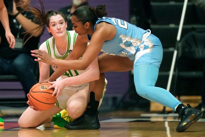 Oregon forward Grace VanSlooten (40) and North Carolina guard Deja Kelly, right, battle for a loose ball during the first half of an NCAA college basketball game at the Phil Knight Invitational tournament Thursday, Nov. 24, 2022, in Portland.