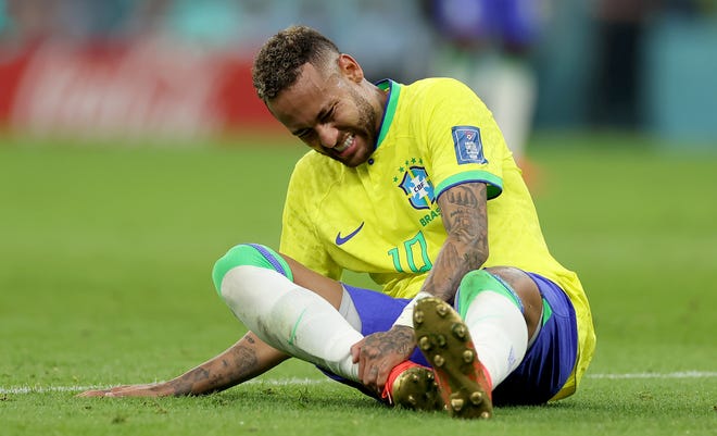 Neymar of Brazil sits injured on the pitch  during the FIFA World Cup Qatar 2022 Group G match between Brazil and Serbia at Lusail Stadium on November 24, 2022 in Lusail City, Qatar.