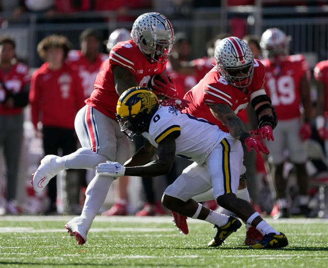 Nov 26, 2022; Columbus, OH, USA; Ohio State Buckeyes running back Miyan Williams (3) runs the ball against Michigan Wolverines defensive back Mike Sainristil (0) in the second quarter of their game at Ohio Stadium. 