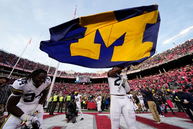 11/26/2022;  Columbus, Ohio, USA;  Michigan Wolverines linebacker Michael Barrett (23) waves the Michigan flag after their 45-23 win over the Ohio State Buckeyes in the NCAA football game at Ohio Stadium.  Mandatory Credit: Adam Cairns-The Columbus Dispatch