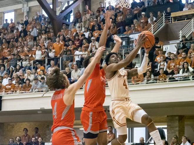 Texas guard Tyrese Hunter goes up to shoot against UT Rio Grande Valley guard Will Johnston, left, and forward Ahren Freeman during the Longhorns' 91-54 win Saturday at Gregory Gym. Hunter had 17 points in the victory.