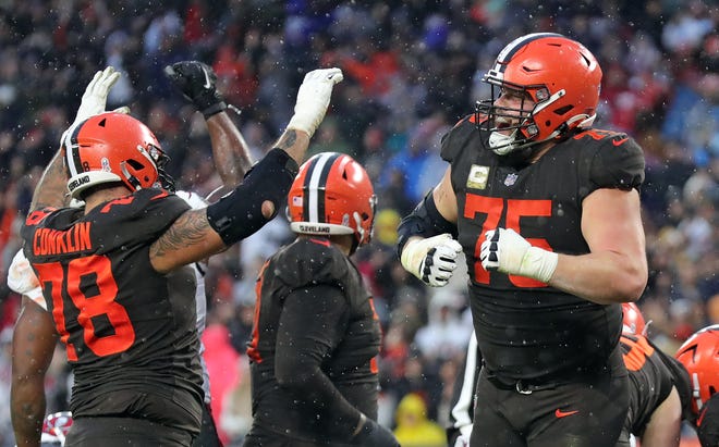 Browns guard Joel Bitonio (75) and tackle Jack Conklin (78) celebrate after Nick Chubb scored the game-winning touchdown in overtime against the Buccaneers, Sunday, Nov. 27, 2022, in Cleveland.