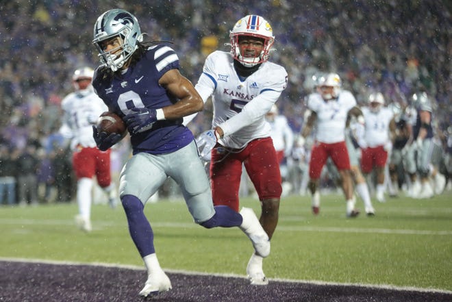 Kansas State wide receiver Phillip Brooks scores on a 14-yard pass from Will Howard in front of Kansas safety O.J. Burroughs during the second quarter Saturday night at Bill Snyder Family Stadium.