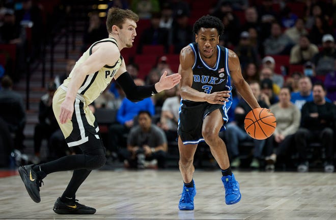 Duke guard Jeremy Roach, right, dribbles past Purdue guard Braden Smith during the first half of an NCAA college basketball game in the Phil Knight Legacy Championship in Portland, Ore., Sunday, Nov. 27, 2022. (AP Photo/Craig Mitchelldyer)