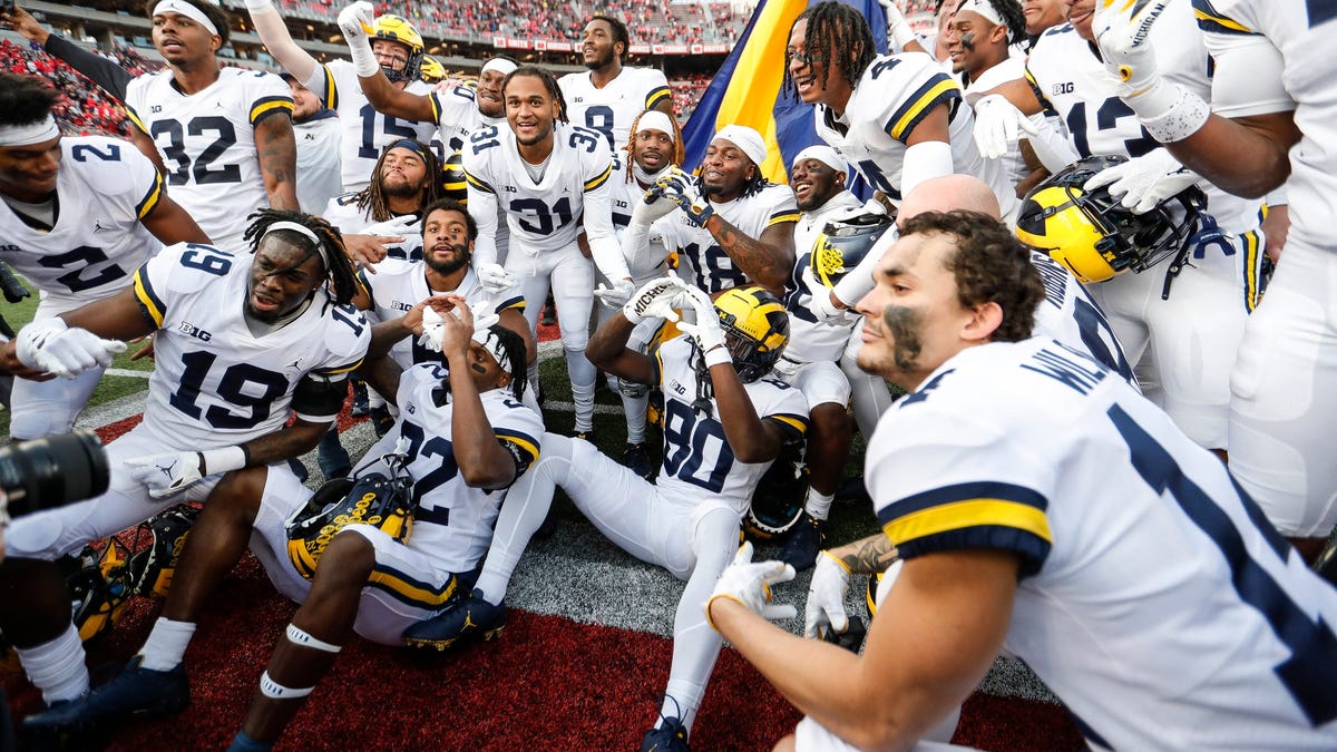 Michigan players celebrate on the field after their defeat of Ohio State at Ohio Stadium, Saturday Nov. 26, 2022.