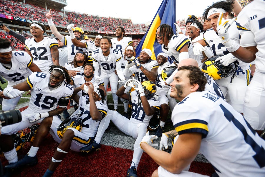 Michigan players celebrate on the field after their defeat of Ohio State at Ohio Stadium, Saturday Nov. 26, 2022.