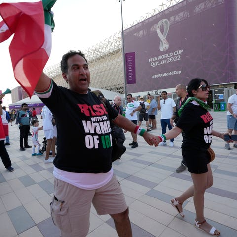 Protesters wear t-shirts reading "Rise with the wo