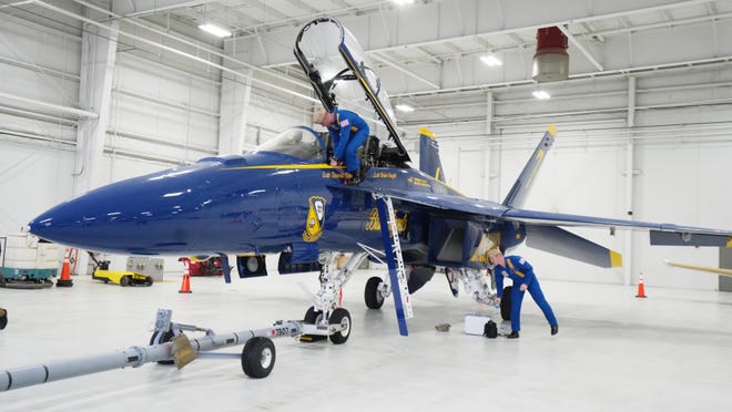 U.S. Navy Lt. Cmdr. Brian Vaught, near cockpit, and Lt. Cmdr. Thomas Zimmerman store their Blue Angels jet at Rickenbacker Aviation logistic services Monday at Rickenbacker International Airport before meeting with officials from 2023 Columbus Air Show, which is being presented June 16-18, 2023 by Scotts.