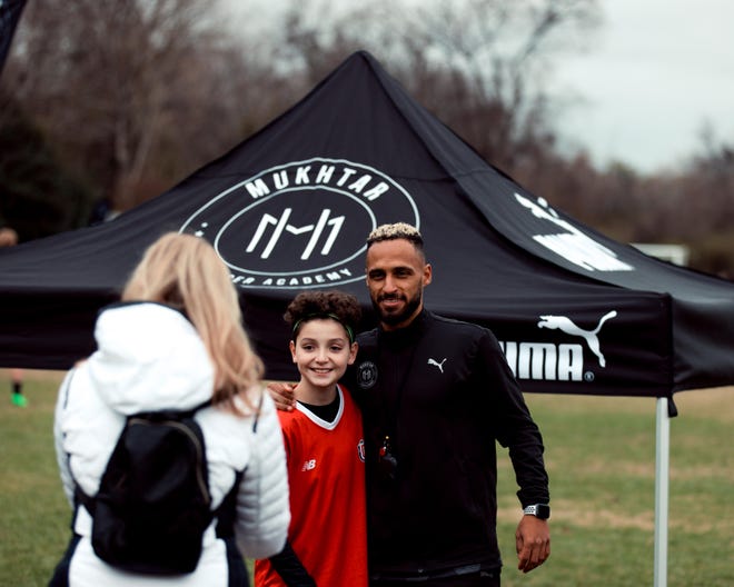 Nashville Soccer Club forward Hany Mukhtar (right) poses with a youth player at the inaugural Mukhtar Soccer Academy clinics at Lipscomb Academy.  Nov.  25, 2022.