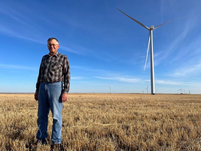 Nick Nemec stands in front of a wind turbine on his land near Highmore.