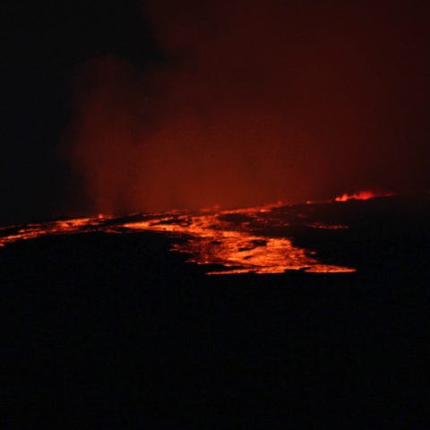 Lava pours out of the summit crater of Mauna Loa a