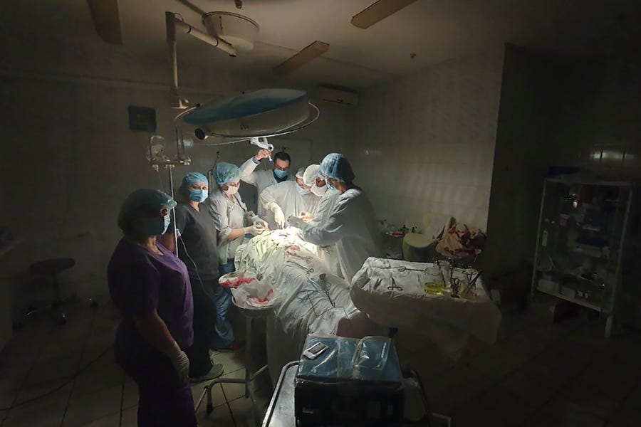 This photo made available by Ukrainian doctor Oleh Duda shows the moment when lights at a hospital went out as he was performing a complicated, dangerous surgery on a bleeding patient at the hospital in the western city of Lviv, Ukraine, Tuesday, Nov. 15, 2022. Russia's devastating strikes on Ukraine's power grid have strained and disrupted the country's health care system, already battered by years of corruption, mismanagement, the COVID-19 pandemic and nine months of war.