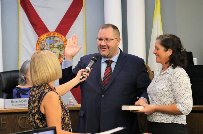 With his wife Kate holding the bible, Venice Mayor Nick Pachota recites the oath of office, as administered by Venice City Clerk Kelly Michaels Tuesday morning.