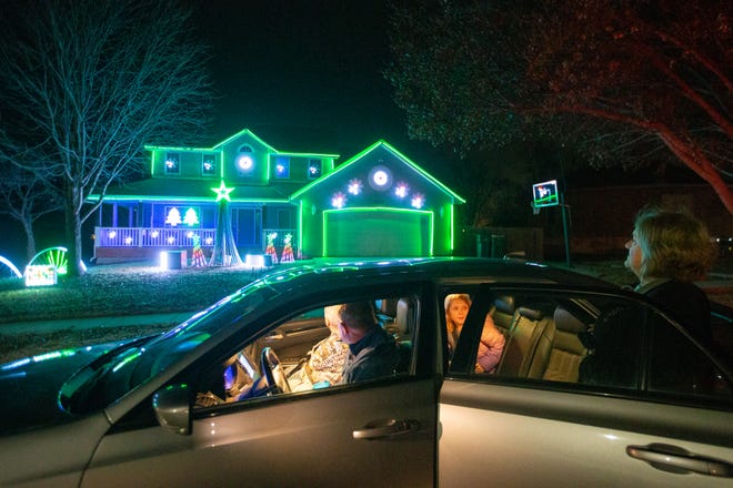 Traveling from their homes in Meriden to see some of the light display around Shawnee County, the Well's family stops in front of the Evans Christmas Lights, 4300 S.E Michigan Ave., Monday evening to enjoy the sights and sounds from their car.