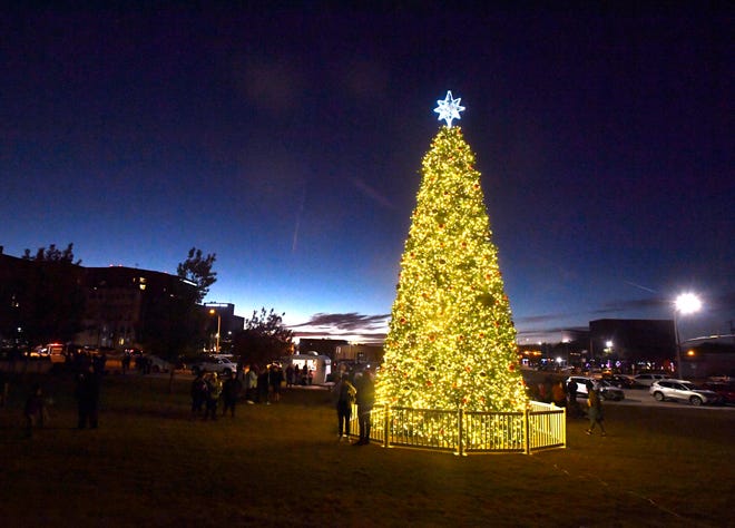 Abilene's Christmas tree glows against the twilight Monday, Mayor Anthony Williams and other city officials held the official lighting ceremony on the City Hall lawn, which was attended by dozens of families with live entertainment from Revolution Strings and Texas Tornadoes line dance troupe.