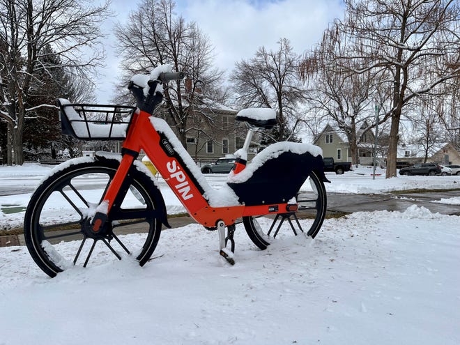 A Spin electric bike sits in the snow on Thursday in Old Town Fort Collins.