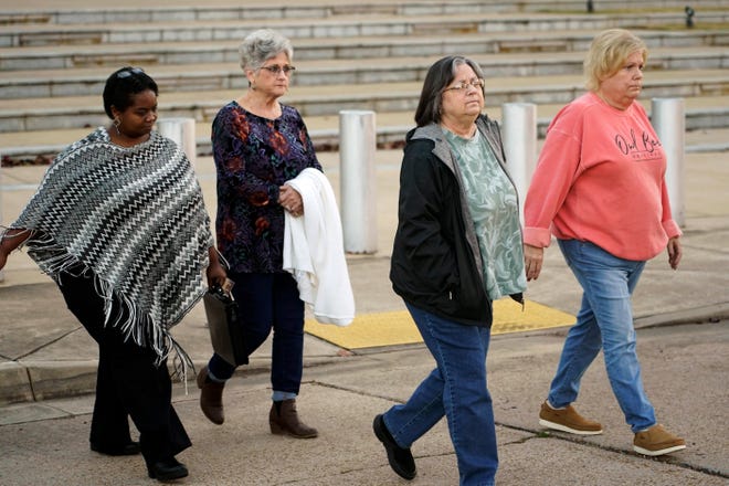 Wanda Farris, the mother of slain teenager Leesa Gray, second from right, is surrounded by supporters as she leaves the federal courthouse in Jackson, Miss., on Monday, Nov. 28, 2022, after they listened to several hours of arguments about Mississippi's three-drug protocol for executions. Thomas Edwin Loden Jr. pleaded guilty in 2001 to capital murder, rape and four counts of sexual battery in the 2000 death of Gray, a 16-year-old waitress from north Mississippi. Loden is a plaintiff in the lawsuit. The Mississippi Supreme Court has scheduled his execution for Dec. 14, 2022. (AP Photo/Rogelio V. Solis)