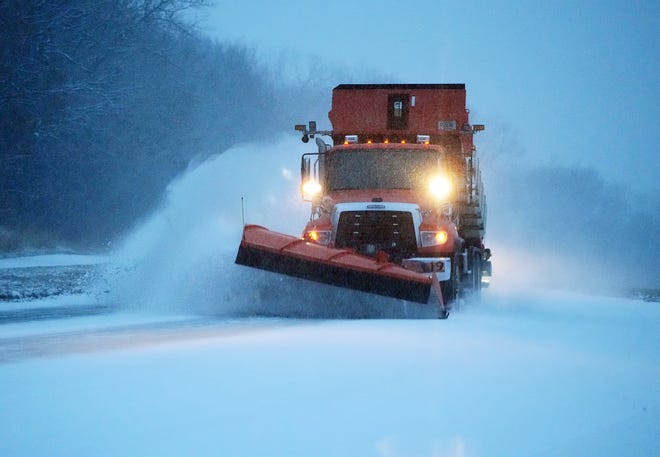 A snowplow pushes fresh snow on  Nov. 29, 2022, in Apple Valley, Minn.